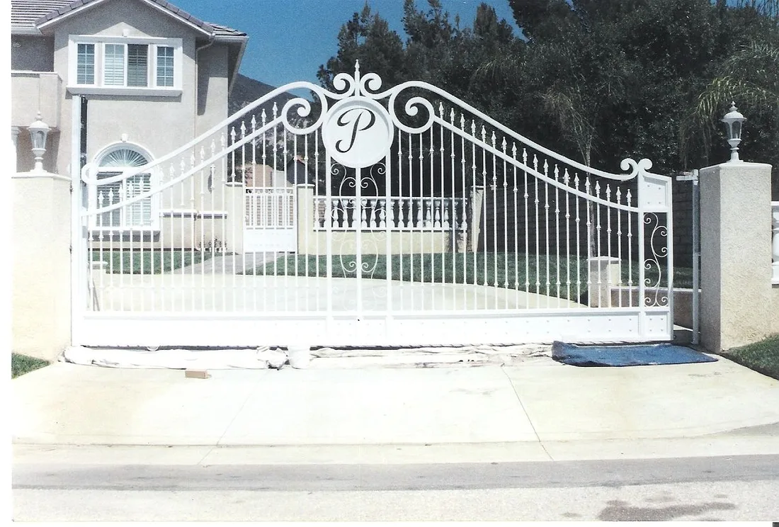 White scrollwork driveway gate