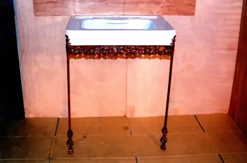 Hand-forged iron sink stand with grape cluster details
