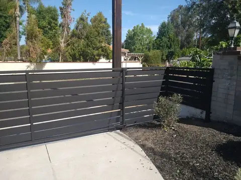 Modern horizontal slat fence and gate in dark gray