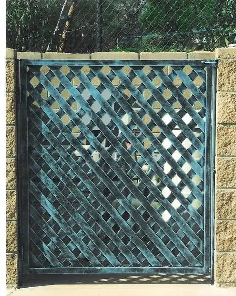 Lattice-pattern driveway gate in a verde green finish