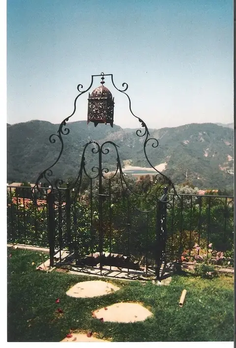 Garden arbor gate with a hanging lantern overlooking the hills