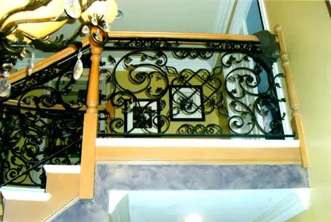 Landing railing with scrollwork and a diamond medallion centerpiece