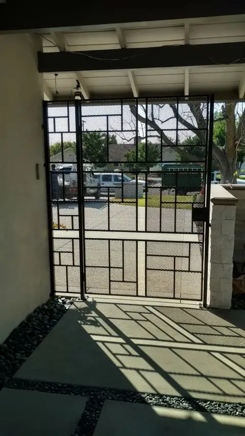 Geometric-pattern pedestrian gate in a covered entry