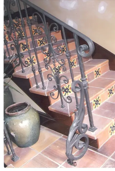Tiled staircase railing with a scrolled newel post