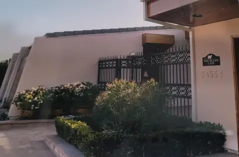 Entry gates with scrollwork bands at a modern home