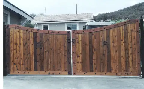 Wood double driveway gates with iron ring latches and strap hinges