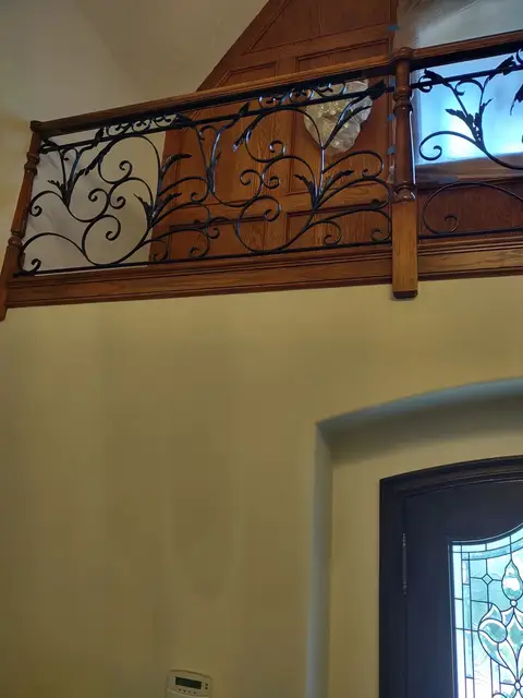 Mezzanine railing with hand-forged vine scrollwork