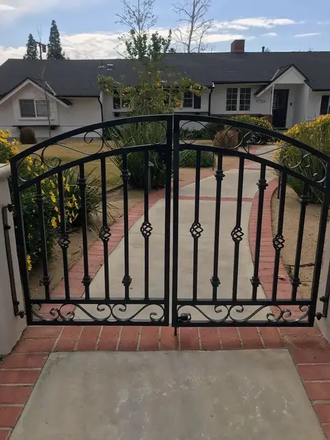 Double walkway gates with diamond accents and a scrollwork base