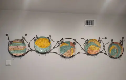 Iron vine wall art holding decorative ceramic plates