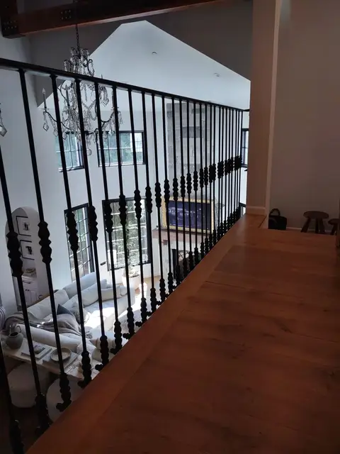 Landing railing with straight bars overlooking a great room