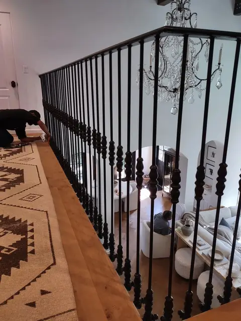 Straight-bar interior railing with knuckle details during installation