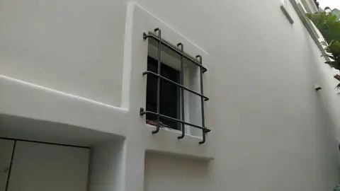 Iron window guard on a stucco home