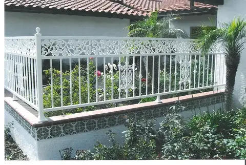 White terrace railing with a floral scroll top rail
