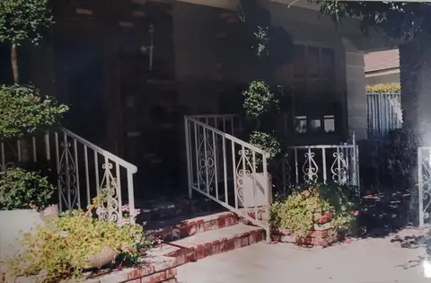 White porch railings with scroll panels at a front entry