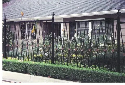 Front yard fence with crossed bars and finial posts
