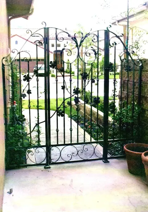 Double garden gates with floral scrollwork