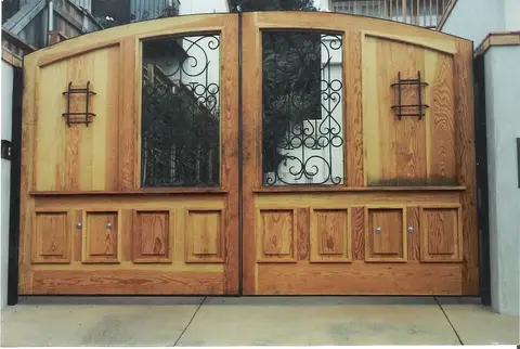 Wood and iron double driveway gates with scrollwork grille windows