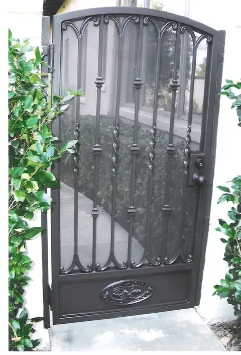 Pedestrian gate with a mesh panel and medallion kick plate